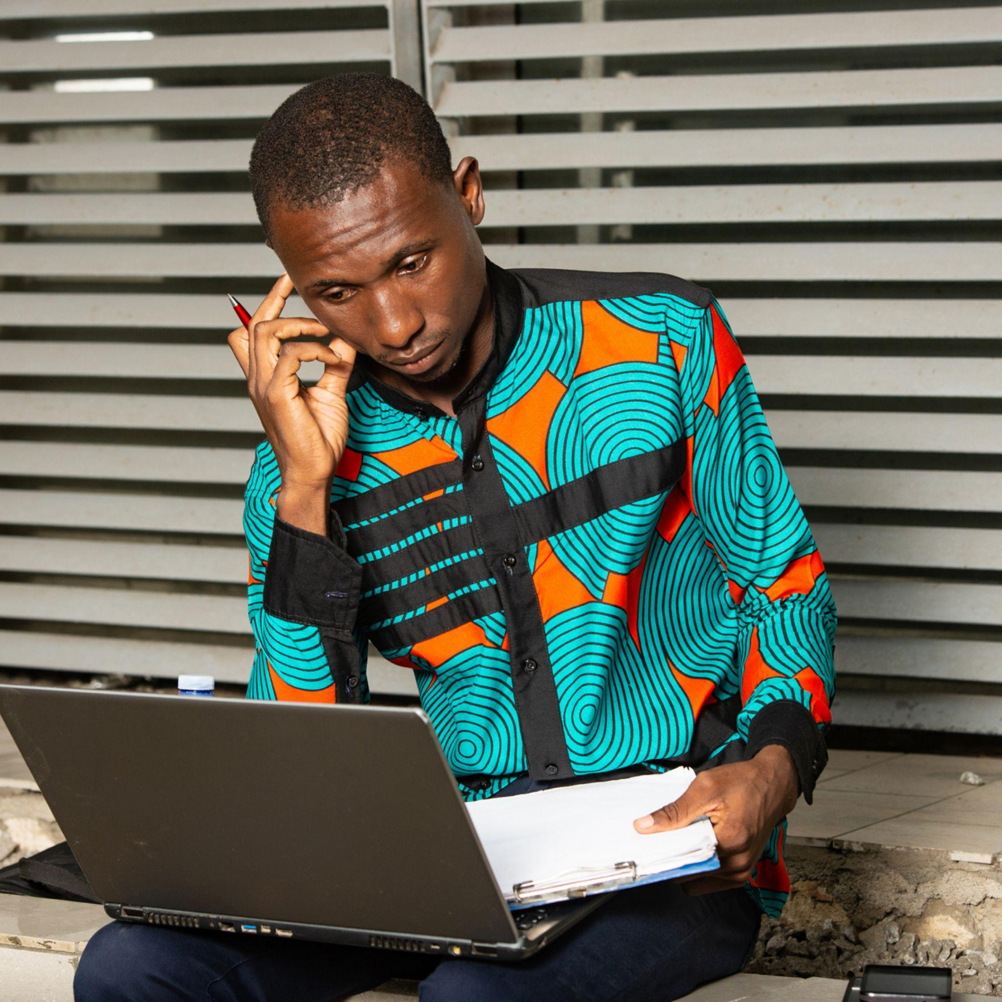 A new business owner working from his house instead of hiring an office space for a start.