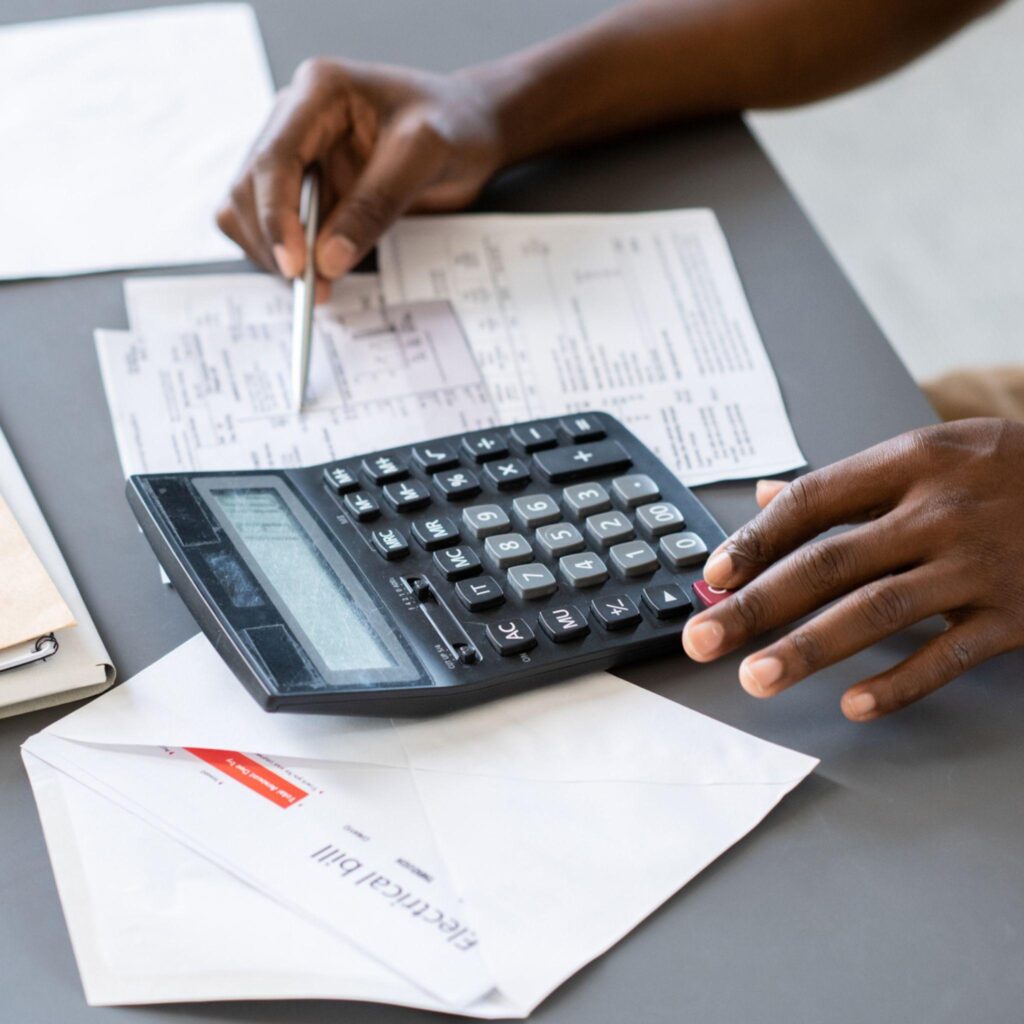 Businessman calculating the cost of production to determine the price of products.